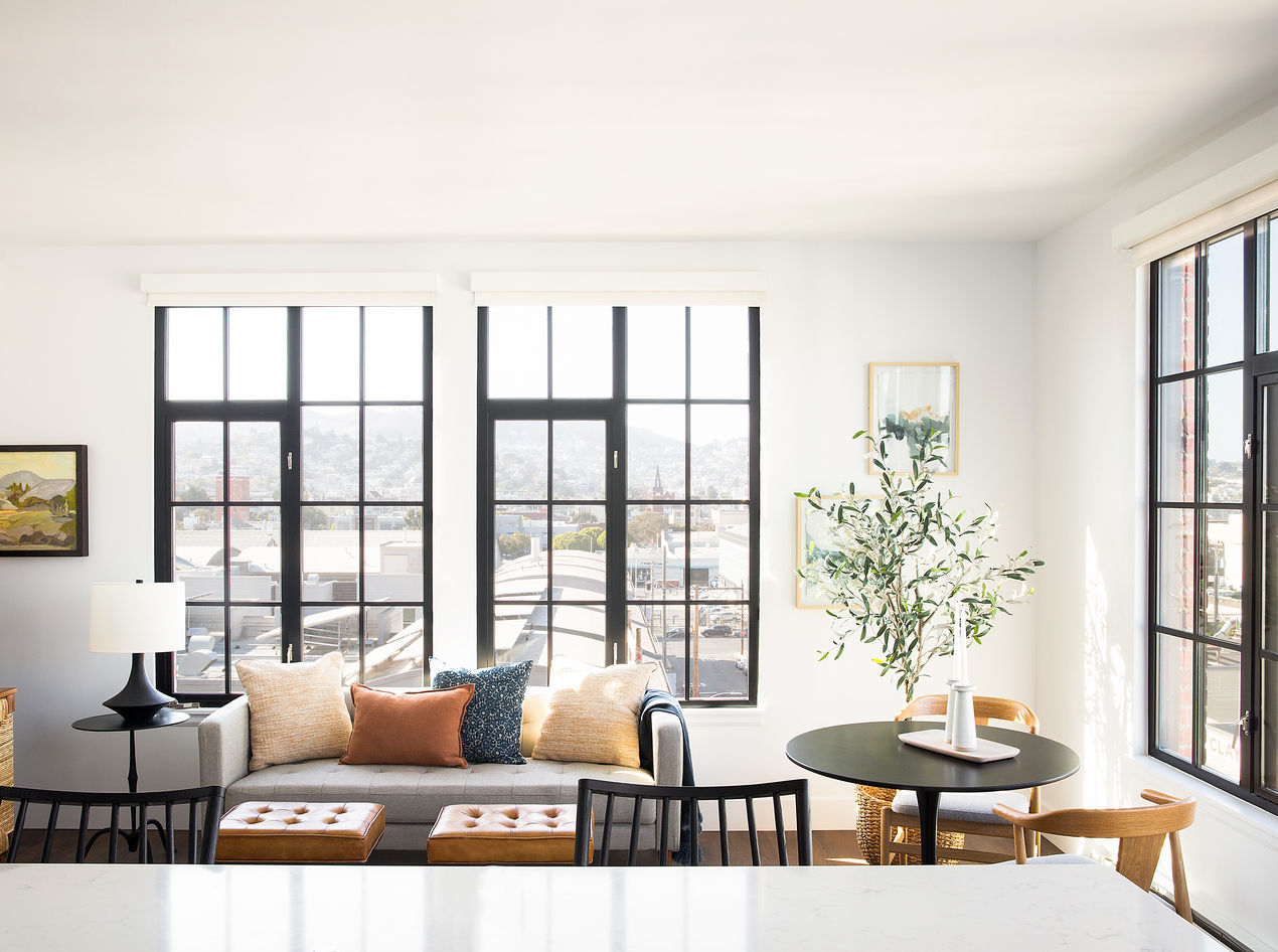 View of an apartment living room with a black dining table | Blog | Greystar 